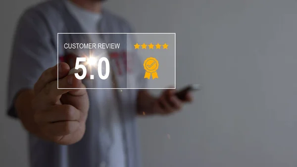 Customer pointing fingers on virtual screen choose to rate service on five-star rating of 5.0. Customer service concept, experience, and high satisfaction.