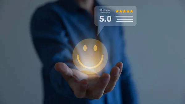 Beş yıldızlı gülen suratlı bir iş adamı online değerlendirme ürünü ve hizmeti için bilgisayar dizüstü bilgisayarı kullanıyor. Müşteri memnuniyeti kavramı..