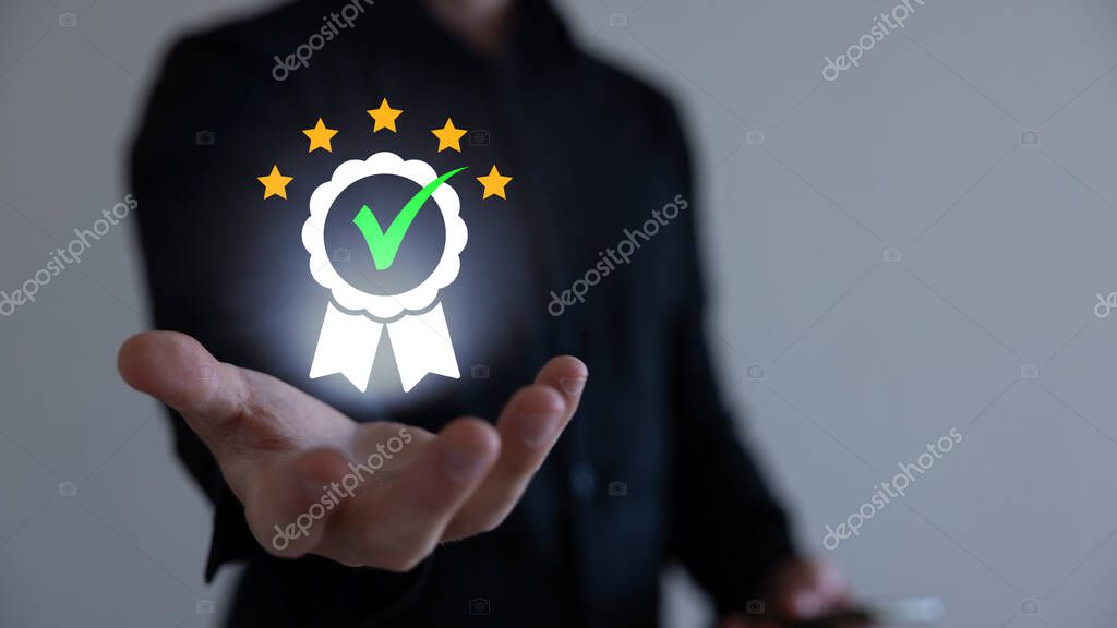 Businessman holding and showing the best quality assurance with golden five stars for guarantee product and ISO service concept.