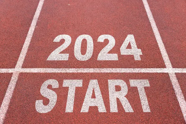 happy new year 2024 symbolizes the start of the new year. Rear view of a man preparing to run on the athletics track engraved with the year 2024. The goal of Success. Getting ready for the new year.