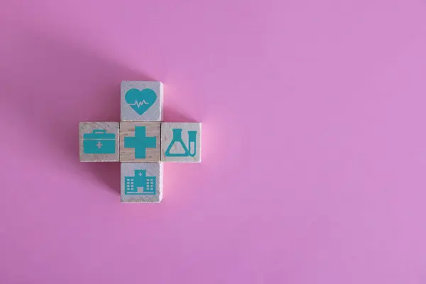 Hand holding heart with elderly inside icon on wood block cube put on top of pyramid for elder care, nursing home, health and medical concept.
