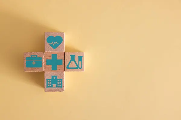 Hand holding heart with elderly inside icon on wood block cube put on top of pyramid for elder care, nursing home, health and medical concept.