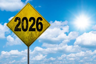 2026 Metal signpost with yellow dirty road sign. Image of a signpost pointing in the direction of the year 2026 clipart