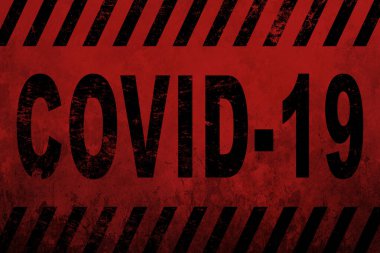 Kaba kırmızı ve pembe duvardaki yazı Covid 19.