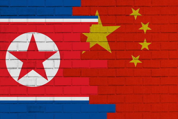 Grunge country flag illustration cracked concrete background China vs North korea Political or economic conflict