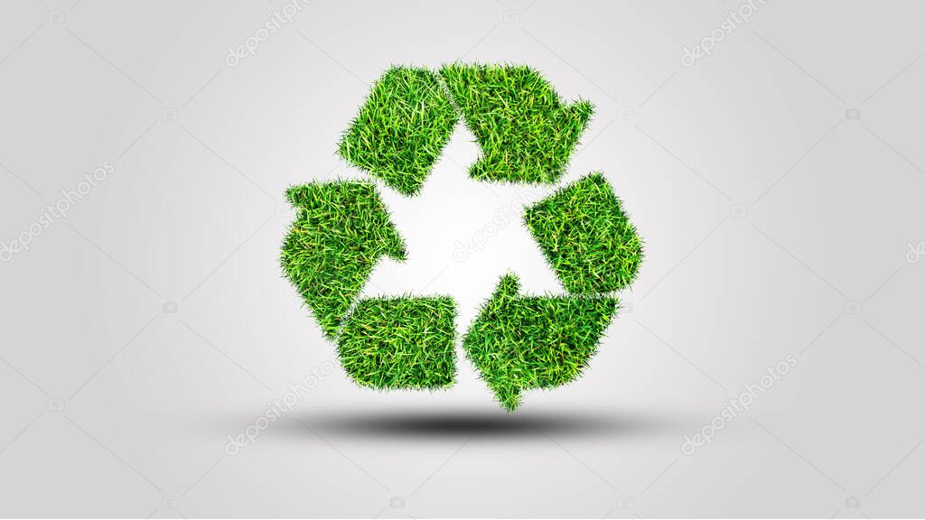 Recycle logo symbol from the green grass, isolated on white
