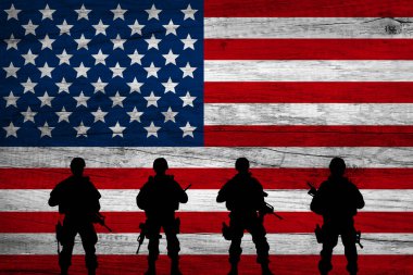 War in USA, shadow of soldiers in the battlefield on dirty flag USA, war crisis concept in USA