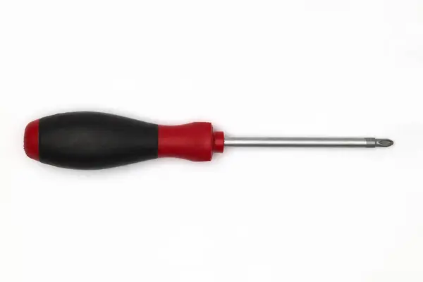 十字尖螺丝刀 黑色和红色的柄放在白色表面上 螺丝刀一种为转动螺丝而设计的手动工具它由一个手柄和一个带有交叉形尖端的轴组成 用于安装在螺钉的槽或凹槽中 — 图库照片