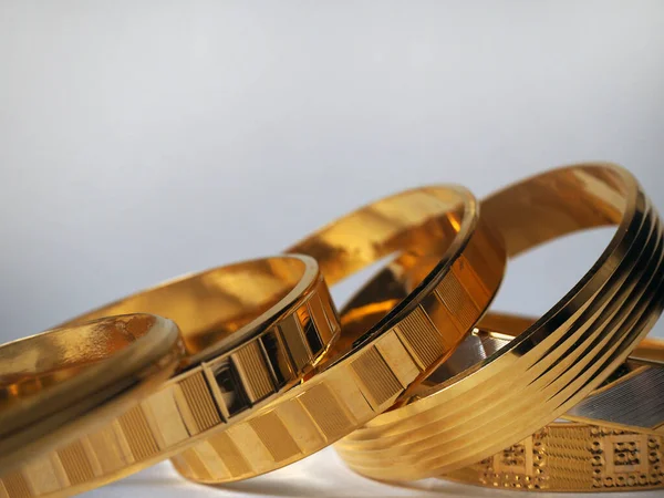 A set of gold bracelets. Isolated golden jewels. Jeweler concept. Copy space.