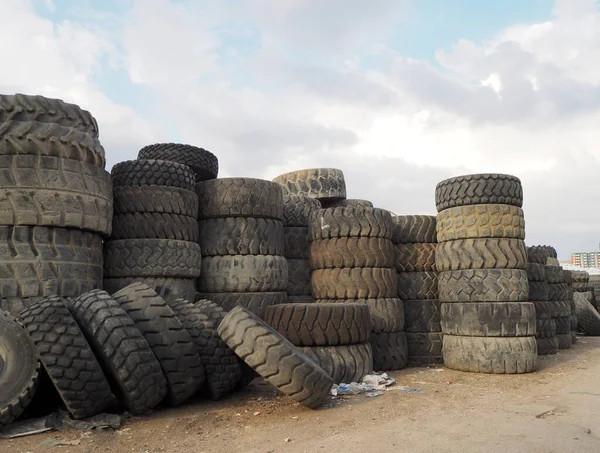 Scrap tires for recycling. End-of-life vehicle wheels in various sizes.