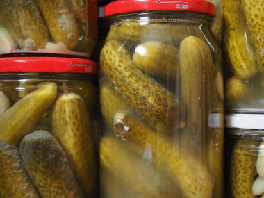 Pickled gherkin in glass jars. Homemade canned food. clipart