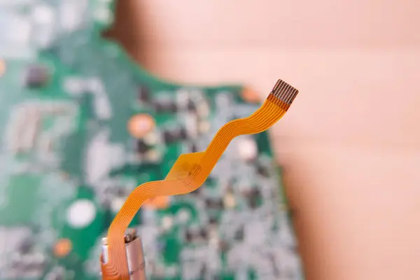 stock image Flexible data cable used in high-tech electronic devices. Focused on the flat cable.