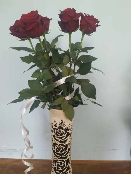 A bouquet of roses in a vase. Red roses