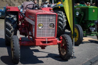 red and white tractor on the street