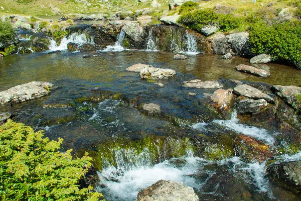 stock image Detail of the watercourse and small waterfalls on the Tristaina glacial cirque route in Ordino, Andorra.