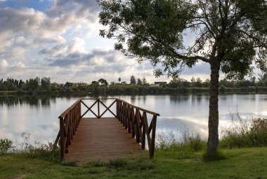 Cloudy sky reflected in the waters of the Ebro River. clipart