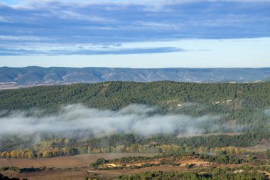 Ormanla kaplı dağlar, Cuenca, İspanya 'da bir sis tabakası oluşmaya başlıyor..