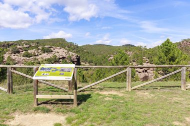 Viewpoint located in front of the Tajadas ravine, we can see how the stone pine (pinus pinaster) tries to make its way through the red rock of Rodano. Teruel, Spain. clipart