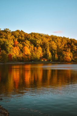 Autumn leaves reflecting on Cheat Lake in West Virginia, USA