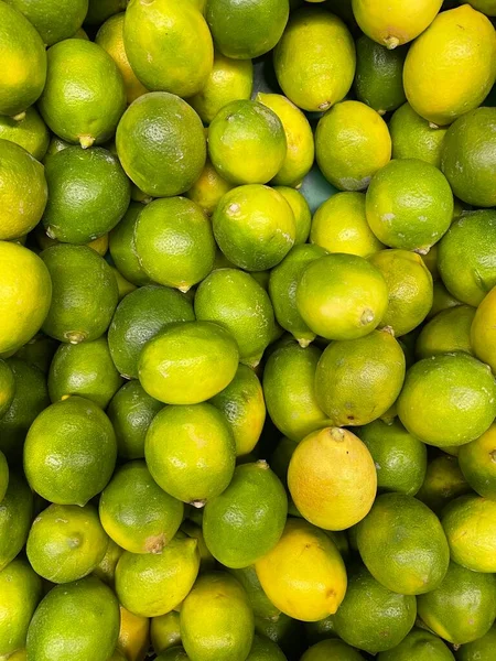 Yellow and green lemons background. High quality photo
