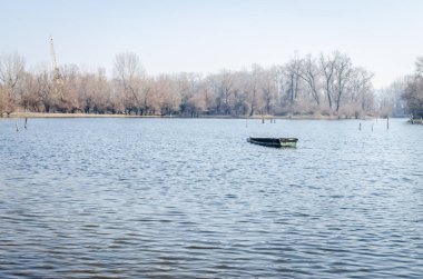 Panoramic view of the Danube river delta in winter. A view of the Danube river delta in winter and the forgotten boats in the water.