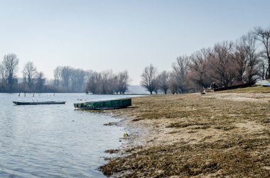 Panoramic view of the Danube river delta in winter. A view of the Danube river delta in winter and the forgotten boats in the water.