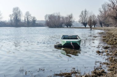 Panoramic view of the Danube river delta in winter. A view of the Danube river delta in winter and the forgotten boats in the water.