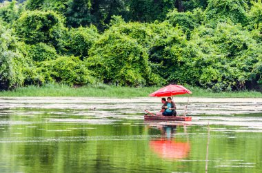 Beautiful panoramic view of the National Park - Sodros, A sport fisherman fishes from his wooden boat.