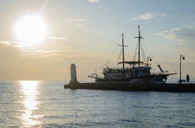 Anchored tourist boat by the waterfront in Pefkochori, Greece. Anchored tourist boat in the morning hours, tied to the waterfront in Pefkochori, Greece.