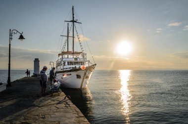 Anchored tourist boat by the waterfront in Pefkochori, Greece. Anchored tourist boat in the morning hours, tied to the waterfront in Pefkochori, Greece.