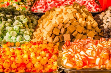 Sweet and sugar colorful candies in the shop for background.