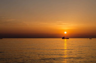 Fishing boat on the high seas, in the early morning hours in Leptokarya,Greece. clipart