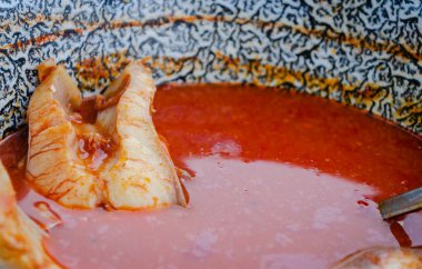 Fish soup served in the restaurant. Served fish soup cooked in a traditional way in a restaurant on the banks of the Danube river.