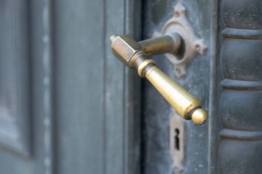 Metal decorative handles. Metal decorative handle on old massive entrance doors.
