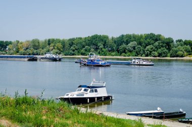 Tugboat on the Danube River. Tugboat passing by moored tankers on the Danube River.