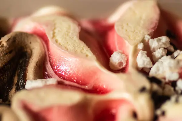 An array of colorful ice cream of different flavors in a plastic box on a hot summer day.