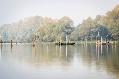 Sports fisherman in a wooden boat in the National Park - Sodros.