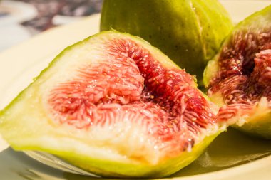 A macro shot inside a fig shows the juicy fruit pulp with seeds. clipart