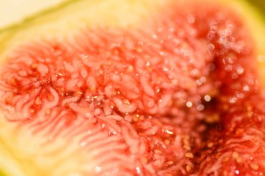 A macro shot inside a fig shows the juicy fruit pulp with seeds. clipart