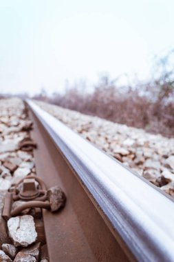 Scenic view of straight railway or railroad track receding into distance on foggy day. The concept of traveling by train.