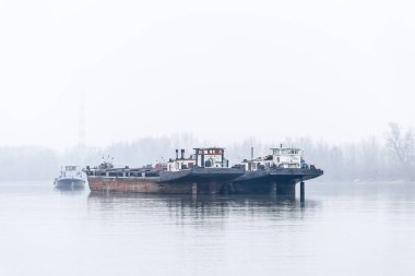 Tankers on the Danube River during the winter period. Anchored tankers on the Danube River in winter.