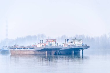 Tankers on the Danube River during the winter period. Anchored tankers on the Danube River in winter.