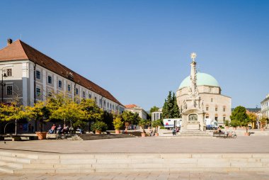 Pecs, Hungary - October 06, 2018: Obeliskl - Monument St. Trinity in Pecs in front of Mosque Qazim in the Main Square in Pecs Hungary.