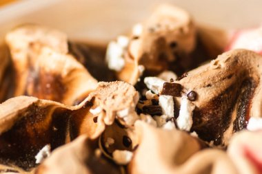 An array of colorful ice cream of different flavors in a plastic box on a hot summer day.