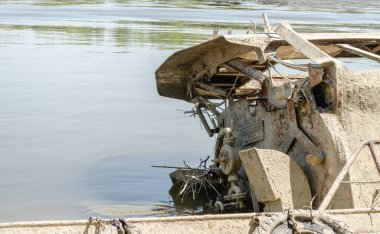 The wreck of an old fishing boat. The wreck of an old fishing boat submerged in the water of the Danube River.