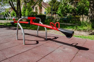 Novi Sad, Serbia. April - 26. 2022. Colorful playground equipment with a variety of toys, including a slide and games to play on a sunny, early spring day.