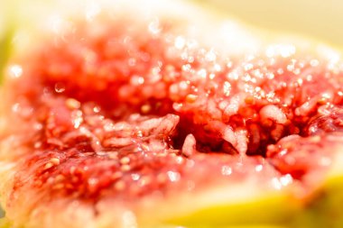 A macro shot inside a fig shows the juicy fruit pulp with seeds. clipart