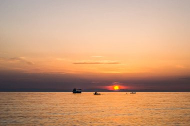 Fishing boat on the high seas, in the early morning hours in Leptokarya,Greece. clipart