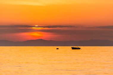 Fishing boat on the high seas, in the early morning hours in Leptokarya,Greece. clipart