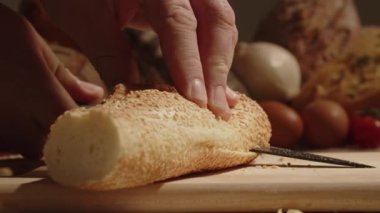 a hand raises a cape with fresh bread under it. traditional recipe with gluten. 4k footage